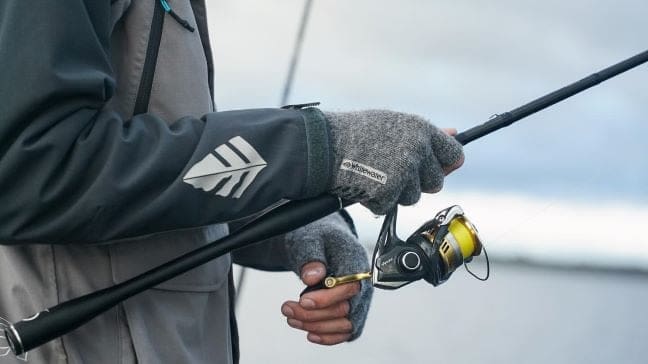 wearing hat and gloves holding fish