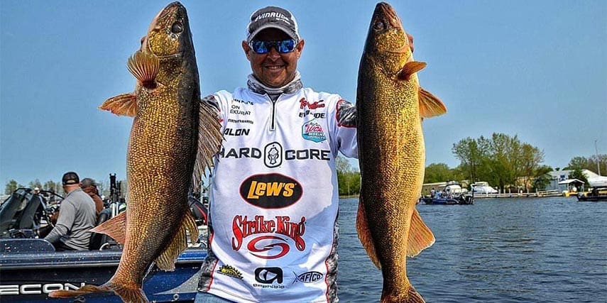 Jason Przekurat holding up two walleye