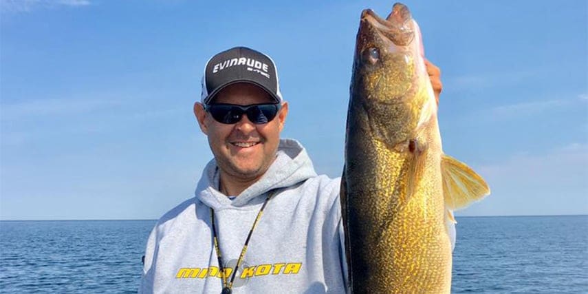 Jason Przekurat holding up a walleye